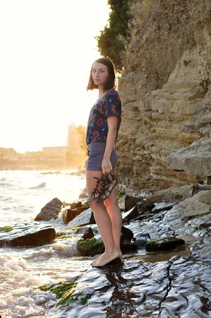 Beautyful girl on the beach during sunsetの写真素材