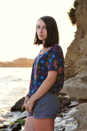 Beautyful girl on the beach during sunsetの写真素材