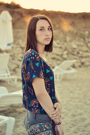 Beautiful girl on the beach during sunsetの写真素材
