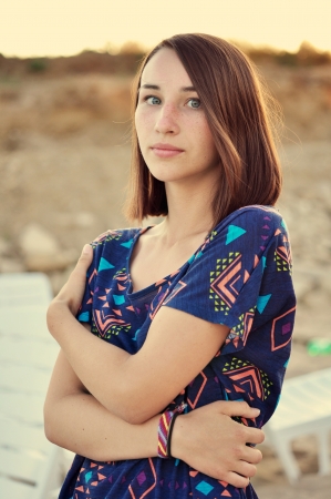 Beautiful girl on the beach during sunsetの写真素材