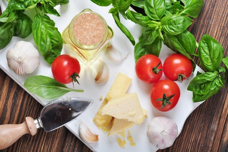 Parmesan cheese with tomatoes and basil on wooden backgroundの写真素材