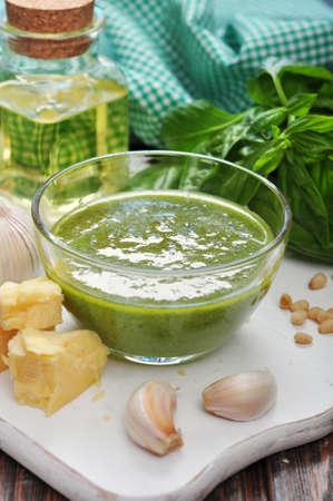 Glass bowl with fresh made Pesto Sauce on wooden backgroundの写真素材