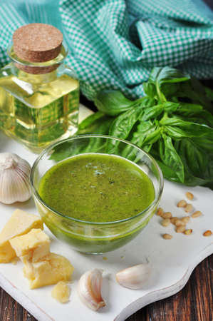 Glass bowl with fresh made Pesto Sauce on wooden backgroundの写真素材