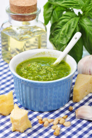 Ceramic bowl with fresh made Pesto Sauce on blue checkered background の写真素材