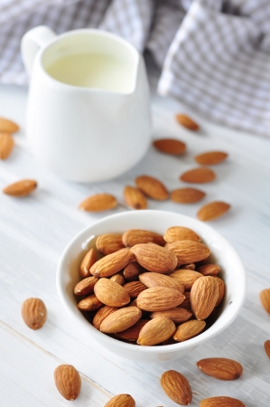 Almond milk with almond on a wooden tableの写真素材