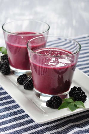 Blackberry smoothie with fresh blackberries on wooden backgroundの写真素材