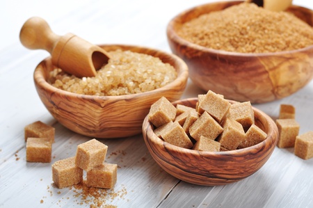 brown and white sugar in wooden bowls closeupの写真素材
