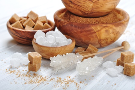 brown and white sugar in wooden bowls closeupの写真素材