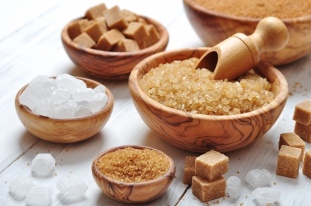 brown and white sugar in wooden bowls closeupの写真素材