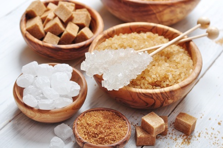 brown and white sugar in wooden bowls closeupの写真素材