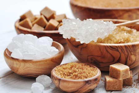 brown and white sugar in wooden bowls closeupの写真素材