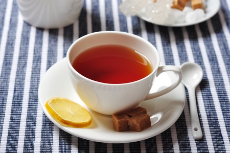 Cup with tea and lemon on blue striped backgroundの写真素材