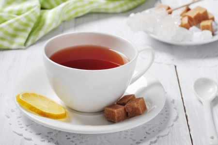 Cup with tea and lemon on wooden backgroundの写真素材