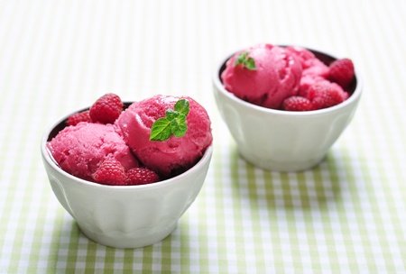  Raspberry ice cream in ceramic bowl with fresh berries and mintの写真素材