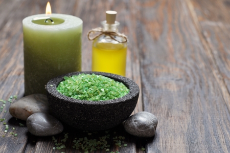 Spa concept. Sea salt in stone bowl with candle and herbal soapの写真素材