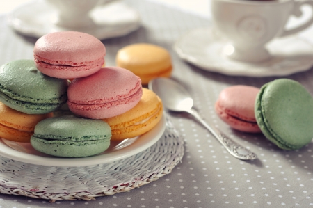 Traditional french pastry - macaroon with cup of tea on beige backgroundの写真素材