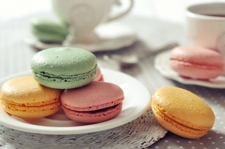 Traditional french pastry - macaroon with cup of tea on beige backgroundの写真素材
