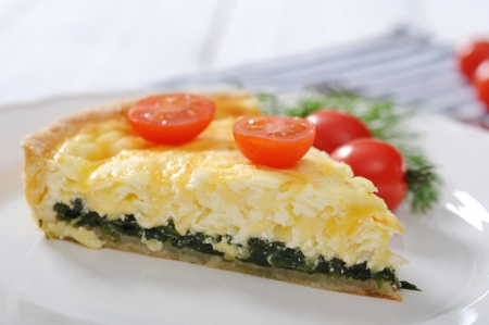 Traditional french quiche pie with spinach and cheese  on a plateの写真素材