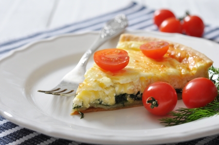 Traditional french quiche pie with spinach and cheese  on a plateの写真素材