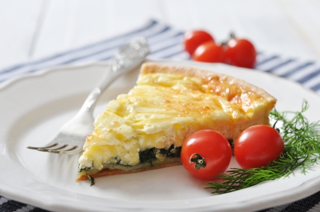 Traditional french quiche pie with spinach and cheese  on a plateの写真素材
