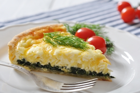 Traditional french quiche pie with spinach and cheese  on a plateの写真素材