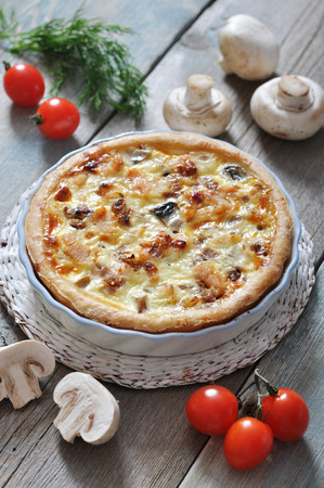 Traditional french quiche pie with chicken and mushroom  on a plateの写真素材