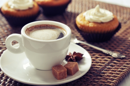 Cup of coffee with muffins on rattan placematの写真素材