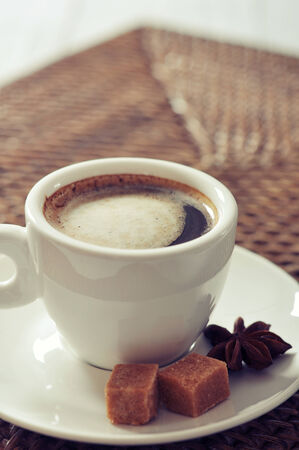 Cup of coffee on rattan placemat closeupの写真素材