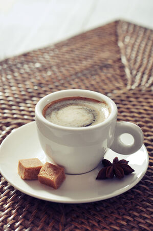 Cup of coffee on rattan placemat closeupの写真素材