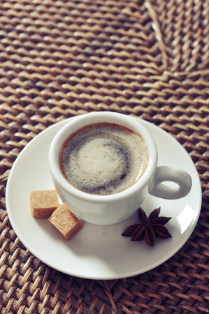 Cup of coffee on rattan placemat closeupの写真素材