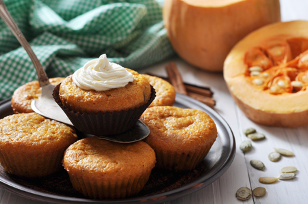 Pumpkin Muffins on vintage wooden table with raw pumpkinの写真素材