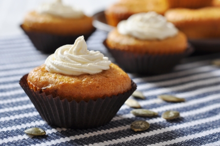 Pumpkin Muffins with whipped cream on blue striped backgroundの写真素材