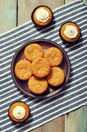 Pumpkin Muffins with whipped cream on blue striped backgroundの写真素材