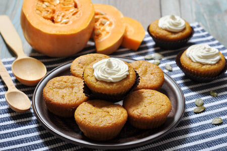 Pumpkin Muffins with whipped cream on blue striped backgroundの写真素材