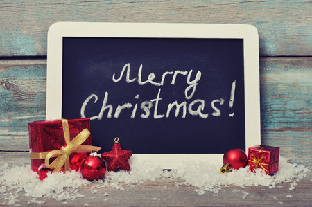 Slate board with Christmas decoration on wooden backgroundの写真素材