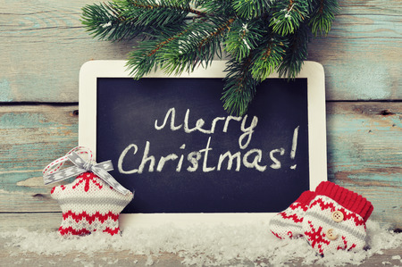 Christmas knitted decoration with  framed blackboard on wooden backgroundの写真素材