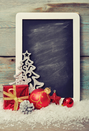 Slate board with Christmas decoration on wooden backgroundの写真素材