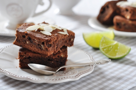 Brownie cake with almond flakes and cup of tea closeupの写真素材