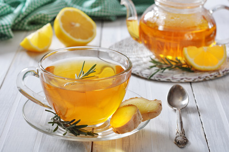 Ginger tea with lemon and rosematy in glass cup closeup.の写真素材
