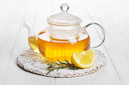 Herbal tea with lemon and rosematy in glass teapot closeup.の写真素材