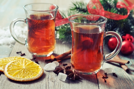 Mulled wine with spices and christmas decoration on wooden backgroundの写真素材