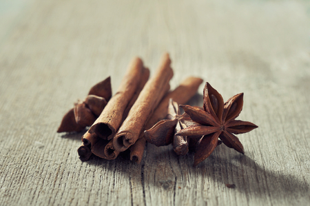 Cinnamon sticks with anis stars closeup on wooden backgroundの写真素材