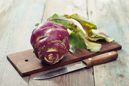 Fresh raw kohlrabi with knife on wooden backgroundの写真素材