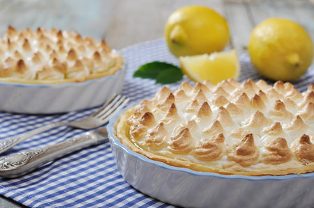 Lemon Meringue Pie with fresh lemons on checkered backgroundの写真素材