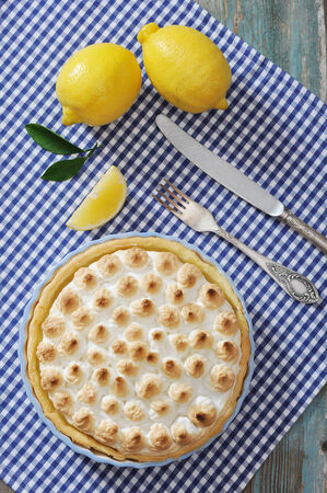 Lemon Meringue Pie with fresh lemons on checkered backgroundの写真素材