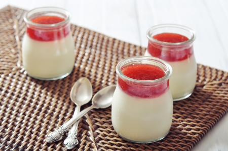 Dessert panna cotta with strawberry souce on wooden backgroundの写真素材