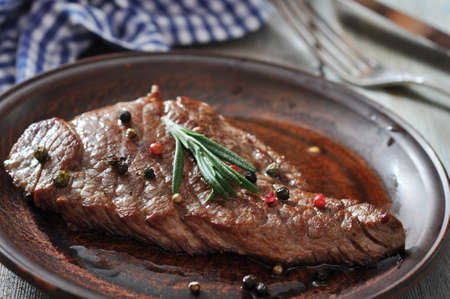 Grilled steak on plate with spices and rosemary closeupの写真素材