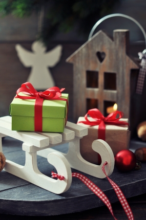 Sled toy with gift boxes and lantern on wooden の写真素材
