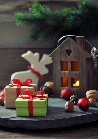 Christmas decorations with gift boxes and lantern on wooden の写真素材