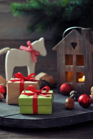 Christmas decorations with gift boxes and lantern on wooden の写真素材